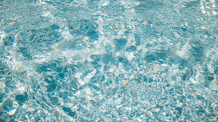 Sunlight creates mesmerizing patterns on the surface of a crystal-clear pool, offering a refreshing...