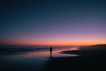 Fototapeta premium Solitary Figure on Beach at Sunset with Crescent Moon