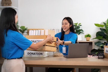 Volunteers teamwork exchanging donations at community center