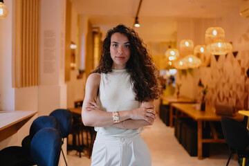 Confident freelancer stands arms crossed, embodying inner strength and digital independence in remote-first business culture driven by self-managed workflow.