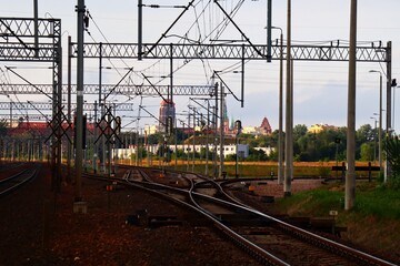 railway tracks and a view of the towers of the monuments of the city of Gdańsk in the distance, Poland