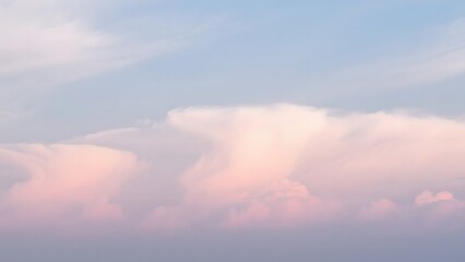 Soft Pink and White Clouds Floating in a Calm Blue Sky