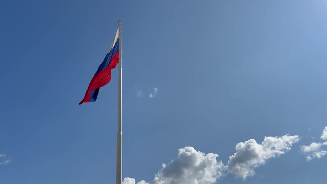 The flag of the Russian Federation on a clear sky background. Russia, Kaluga, 15.08.2025
