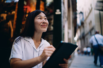 Thoughtful woman pauses with stylus in hand, contemplating next digital move, symbolizing balance...