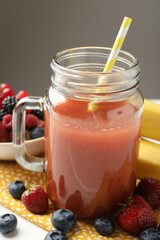 Superfood. Healthy drink in mason jar and ingredients on white wooden table against grey background, closeup