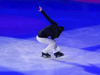 Young Skater Performing a Spin on the ice Rink © GioRez