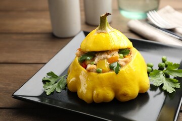 Tasty stuffed pattypan squash on wooden table, closeup
