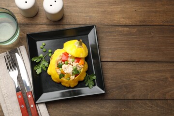 Tasty stuffed pattypan squash served on wooden table, flat lay. Space for text