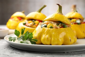 Tasty stuffed pattypan squashes on grey textured table, closeup