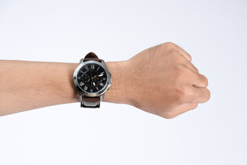 Hand wearing elegant wristwatch with leather strap