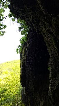 Beautiful slow motion video of the Sipote Waterfall (Cascadele de travertin) on a beautiful sunny summer day. Rain like water droplets falling from the travertine rocks giving a zen vibe. Alba,Romania