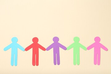 Tolerance concept. Colorful human figures on beige background, flat lay. Space for text