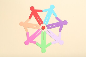 Tolerance concept. Colorful human figures and heart on beige background, flat lay