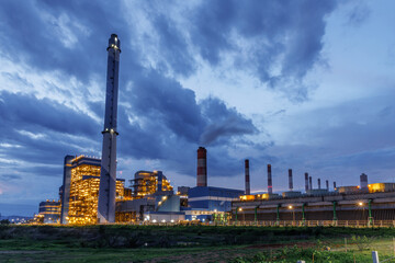 Power plant building, Heavy industry complex gas oil tower building at night time