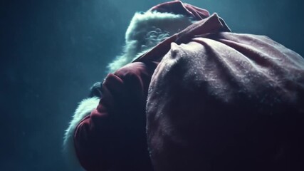 Back view of Santa carrying a large sack over his shoulder