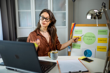 Focused Young Woman on Video Conference from Home