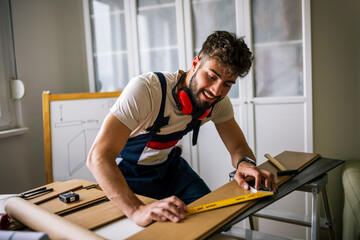 Repairman Measuring Laminate Flooring