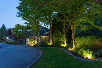 Two story stucco luxury house with nice Spring blossom landscape at night in Vancouver, Canada, North America. May 2025.