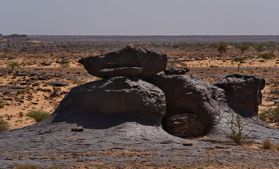 Africa, Mauritania. Giant fragments of rocks of volcanic origin on the rocky plateau of the Agrour...