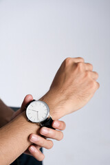 Person wearing wristwatch adjusting time on hand