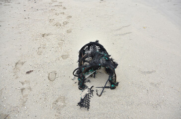Sand Filled Crab Trap Sitting on a Beach