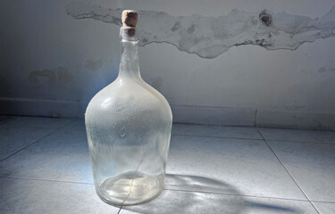 Dusty Glass Demijohn Bottle with Cork in Sunlight