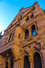 Obraz premium large stone late medieval building with a facade in a pleasant brown is illuminated by the sun