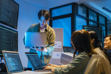 Young Asian man software developers mentor leader manager Verification and validation in software...