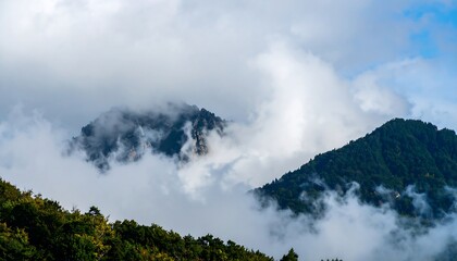 Misty mountain peak shrouded in clouds.