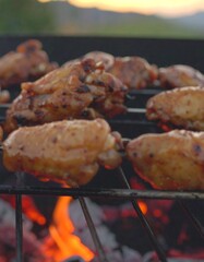 Grilled chicken wings over charcoal