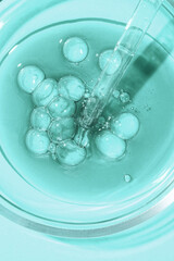 Green colored transparent serum swatch and glass pipette dropper. Beauty product sample swatch backdrop