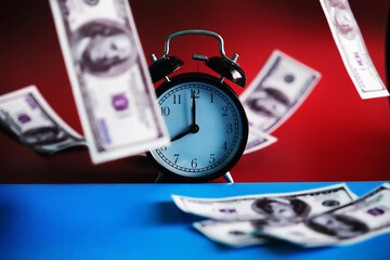 Green dollar bills on a red background. 100 dollar bills close up. The concept of falling wealth....