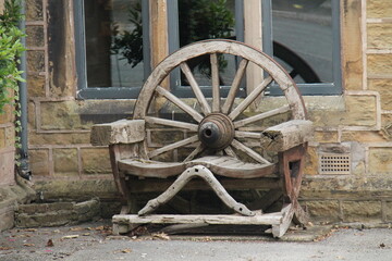 A Vintage Cartwheel Design Wooden Garden Bench.