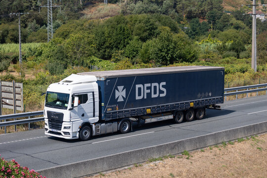 Dfds white and blue semi-trailer truck driving on highway