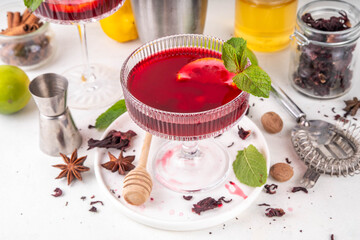 Tasty sweet sour aromatic hibiscus  cocktail with alcohol, spices, honey, lemon or lime juice, copy space 