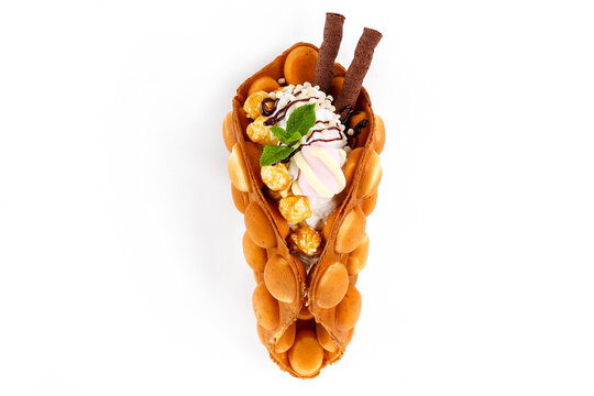 Vanilla Bubble Waffle Dessert with Popcorn, Marshmallow, Whipped Cream, and Chocolate Sticks