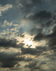 The sky is cloudy and the sun is shining through the clouds