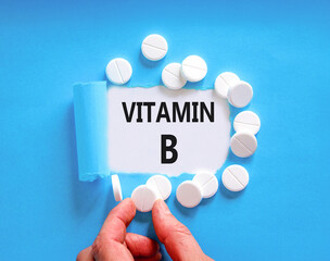 Vitamin B symbol. Concept words Vitamin B on beautiful white paper. White pills tablets. Doctor's...
