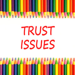 Trust issues symbol. Concept word Trust issues on beautiful white paper. Colored pencils. Beautiful white paper background. Business trust issues concept. Copy space.