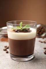Delicious coffee panna cotta, beans and mint on grey table, closeup