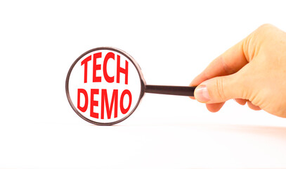 Tech demo symbol. Concept word Tech demo on beautiful magnifying glass. Businessman's hand....