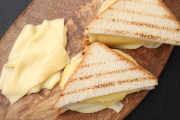 Tasty sandwiches with melted cheese on table, top view