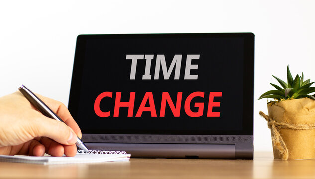 Time change symbol. Concept word Time change on beautiful black tablet. Businessman's hand with pen. Calculator. Beautiful white background. Business time change concept. Copy space.