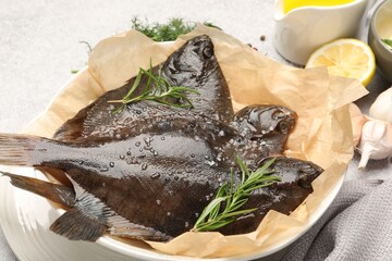 Fresh raw flounder fish and spices on light grey table, closeup. Seafood