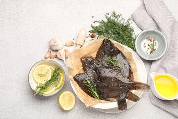 Fresh raw flounder fish and spices on light grey table, flat lay. Seafood
