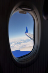 Fototapeta premium View from airplane wing and clouds from window seat during flight