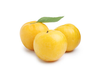 Whole ripe yellow cherry plums with leaf isolated on white