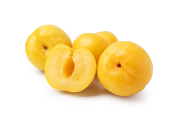 Whole and cut yellow cherry plums isolated on white