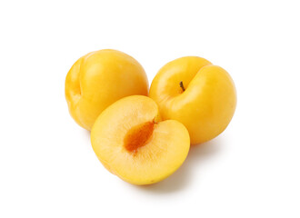 Whole and cut yellow cherry plums isolated on white