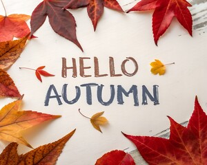 &ldquo;Hello Autumn brush-stroke text with falling red-orange leaves&rdquo;